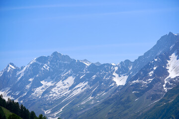 Doing hiking with mountain panorama in the Swiss Alps at Lötschental Valley on a sunny late spring...