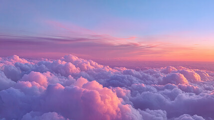 Aerial view of a sea of clouds with pink and purple hues during a vibrant sunset in the horizon