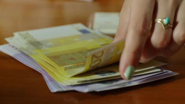 counting 200 euro bills and withdrawing them from the stack in slow motion
