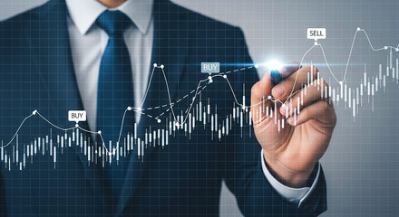 Businessman analyzing stock market chart with buy and sell signals on a digital interface screen
