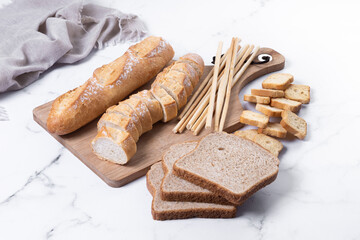 Assortment of Bread Products on white marble background