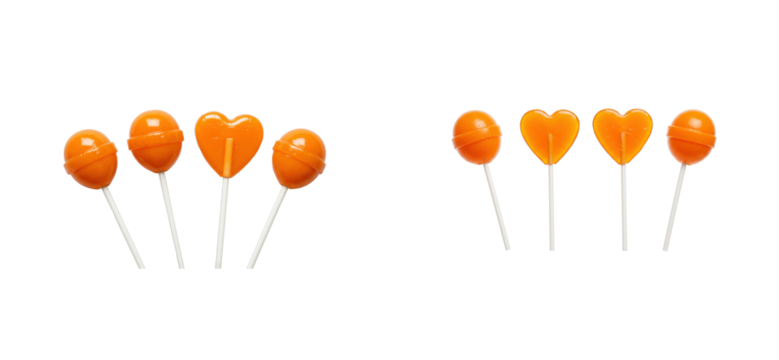 Bright orange heart and round shaped candy lollipops with sticks against black background