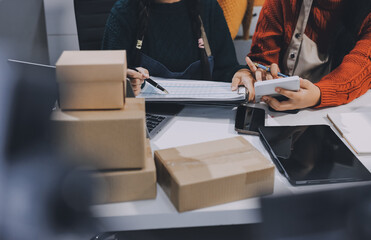 Portrait of Starting small businesses SME owners, two Asian woman check online orders Selling...