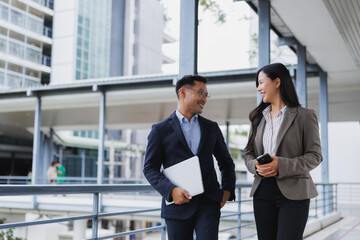 Business people walking and talking in modern city