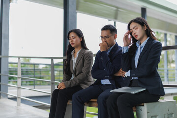 Worried business people sitting and thinking about problem solving strategy