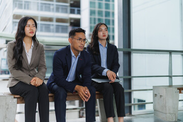 Businesspeople waiting and listening during a presentation in modern office building