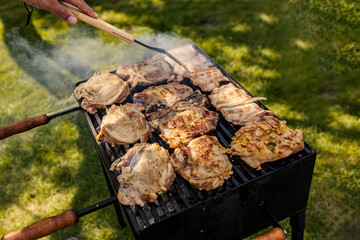 Top view of a man making bbq on a grill in backyard.