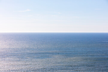 The blue ocean and sky, calm water.