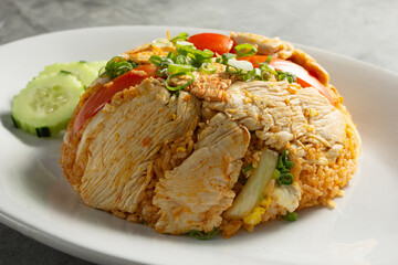 A view of a plate of chicken fried rice.