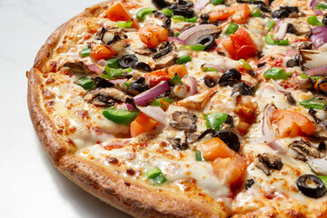 A closeup view of a veggie pizza.