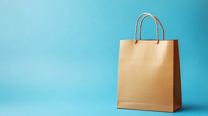 Minimalist Gold Shopping Bag on Light Blue Background with Twine Handles and Shadow