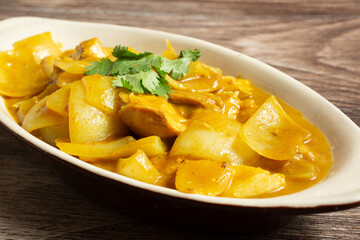A view of a bowl of Chinese style curry chicken.