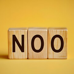 NOO Spelled Out with Wooden Blocks Against a Yellow Background, Studio Shot