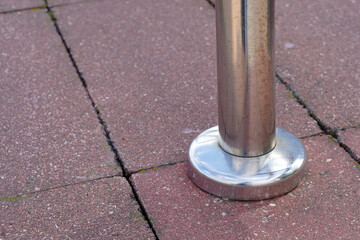 metal gloss handrails built into concrete tiles close-up