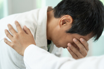 psychiatrist holds shoulders while discussing life and family issues. doctor encourages and empathy...