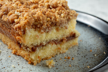 A closeup view of a slice of toffee nut coffee cake.