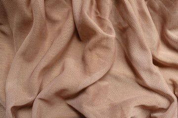 Backdrop - pastel beige unprinted polyester mesh fabric in soft folds