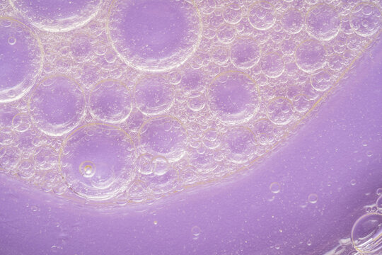 Macro view of oil bubbles with purple background