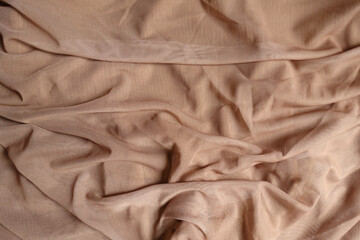 Crumpled pastel beige unprinted polyester mesh fabric