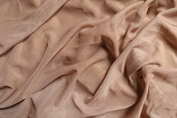 Draped pastel beige unprinted polyester mesh fabric
