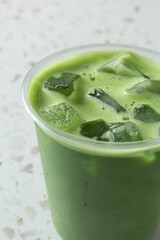 A closeup view of a iced matcha latte.