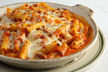 A closeup view of a baked ziti entree.