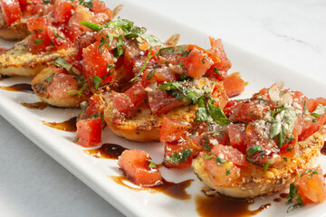 A closeup view of a plate of bruschetta.