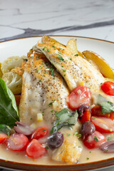 A closeup view of a branzino filet entree.