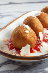 A view of a plate of arancini.