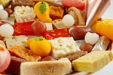 A closeup view of a plate of assorted Indian pastries.