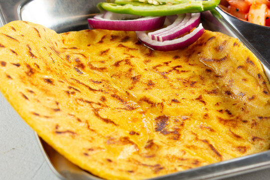 A view of a piece of makki ki roti.