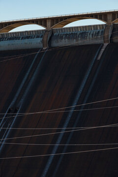 Grand Coulee Dam, close up of the solid dam wall and the bridge and parapet at the top.