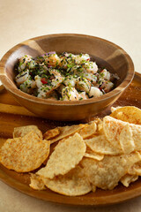 A view of an entree of shrimp ceviche and corn tortilla chips.