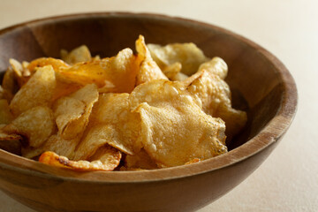 A closeup view of a bowl of potato chips.