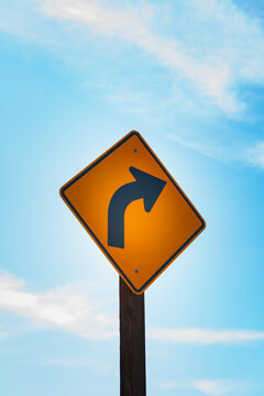Turn arrow symbol on a metal street sign, a right turn sign.