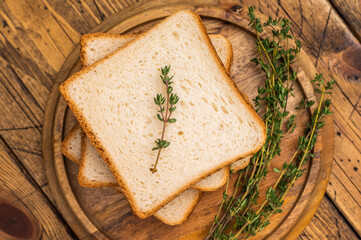 Ready for toasts Slices of wheat bread. wooden background. top view