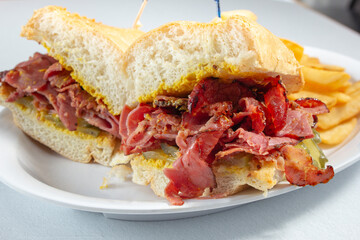 A closeup view of a pastrami sandwich.