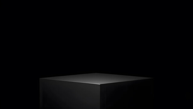 Minimalist black cube pedestal with dramatic spotlight illumination on a dark background