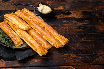 Homemade pastry, Bread sticks with cheese and salt. wooden background. top view