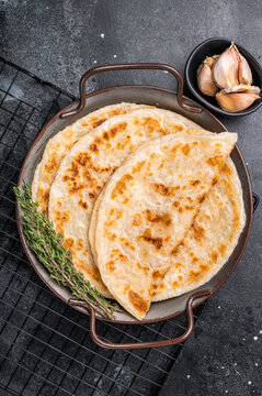 Aloo Paratha Indian Potato stuffed Flatbread. black background. top view