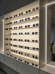 Saint Petersburg, Russia - 07.12.2025. Sunglasses Display Shelves in Modern Eyewear Store.
