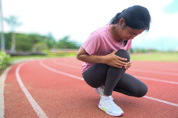 woman runner hold her injured knee