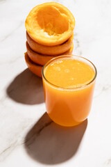 Homemade orange juice with cast shadow isolated on kitchen countertop