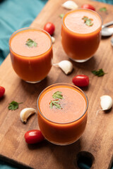 Spanish traditional cold tomato soup, gazpacho, served in small glasses.