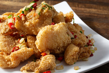 A closeup view of a plate of hot pepper shrimp.