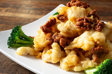 A closeup view of a plate of honey walnut shrimp.