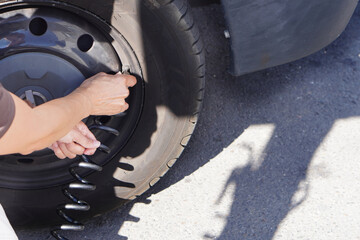 close up of woman's hands inflating the tires of her camper to recommended pressure