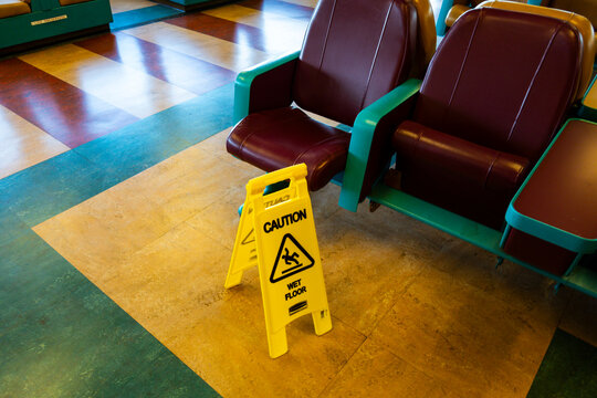 Sign warning of slippery floors on the inside deck of a ferry.