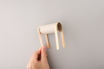 little DIY creation, cardboard tube as body, Four wooden sticks attached underneath resembling...