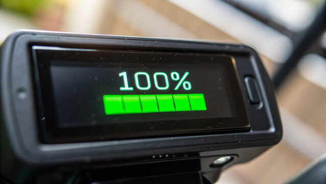 Carbon neutral shipping display shows 100 percent battery charge on digital screen